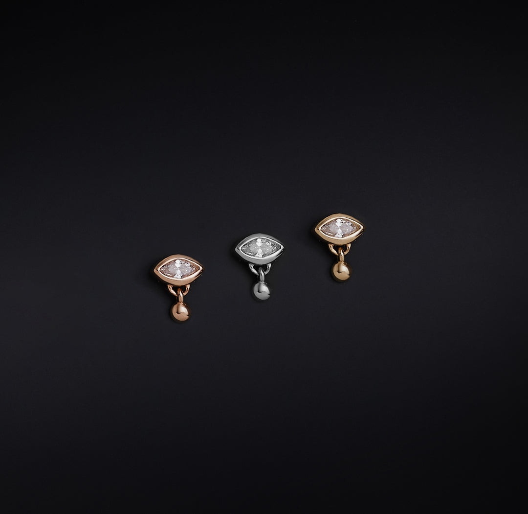 Three eye-shaped drop earings with rose gold, silver and gold as base metals are shown in this picture.